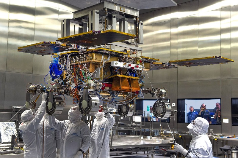 Advanced spacecraft assembly process in a cleanroom setting.