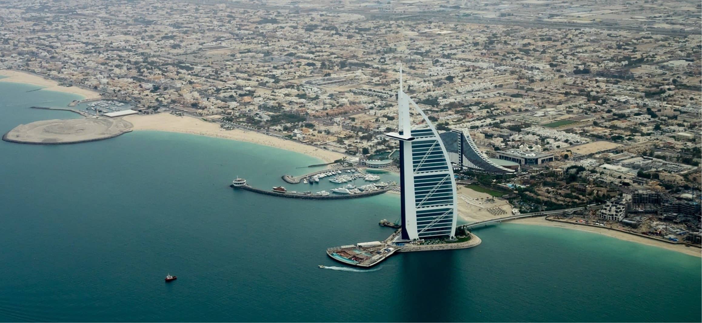 Aerial view of Dubai with the Burj Al Arab, a symbol of modern architecture and luxury.