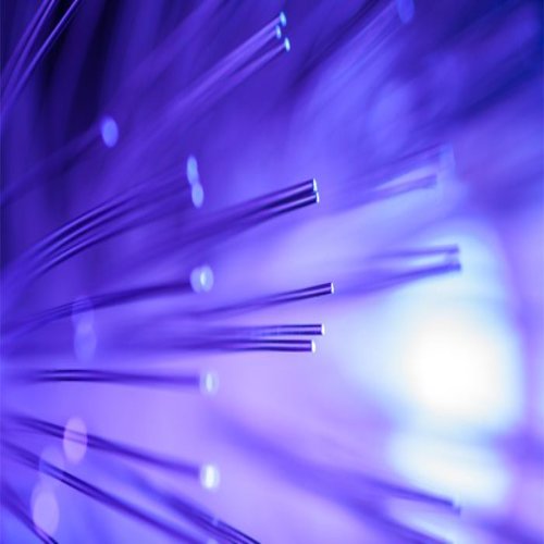 Close-up of fiber optic cables emitting purple light, illustrating advanced communication technology.