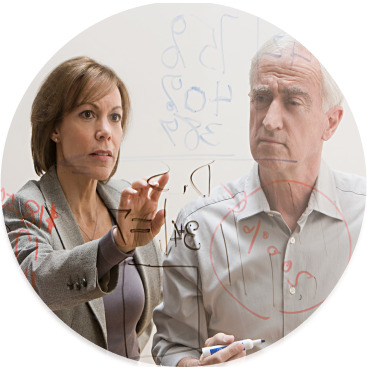 Two professionals collaborating on research ideas with a transparent whiteboard.