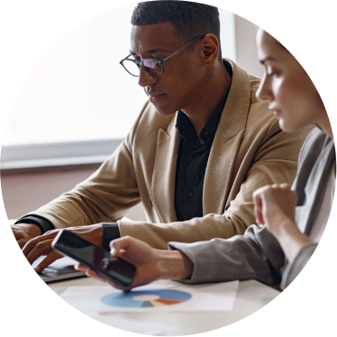 Two professionals reviewing academic research data on a tablet.