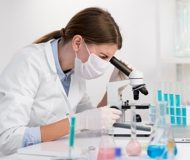 Research scientist examining samples using a microscope for lab analysis.