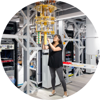 High-tech laboratory with woman working on quantum hardware.