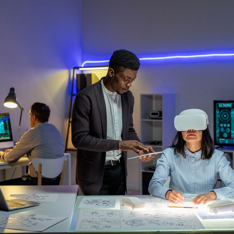 Alt text: Diverse researchers collaborating with VR technology in a modern lab setting.
