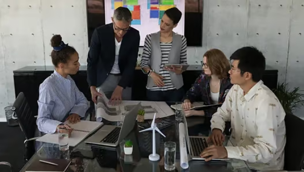 Diverse team collaborating on a project in a modern office setting.