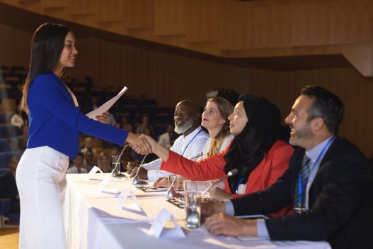 Young woman receiving award at academic conference.