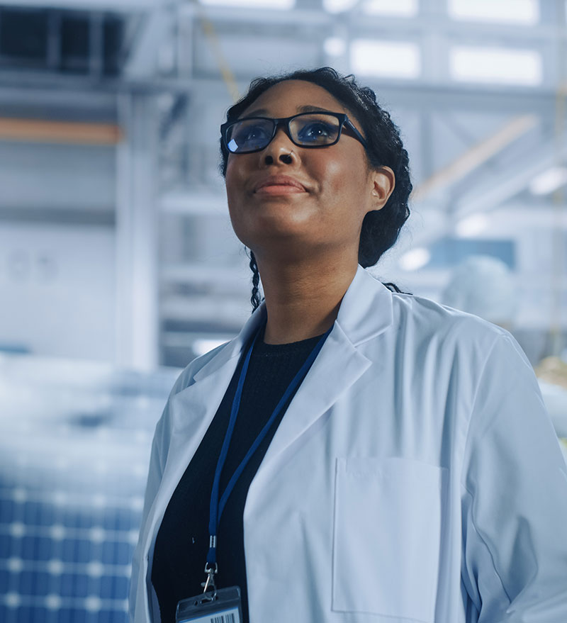 A professional scientist in lab environment researching scientific solutions.