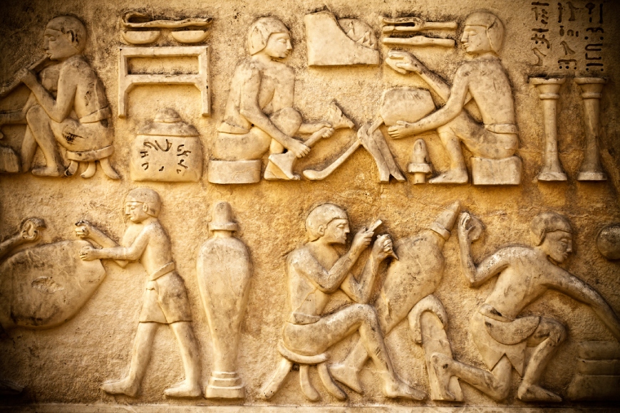 Intricate Egyptian relief showcasing craftsmen at work, emphasizing historical artisan skills and research avenues.