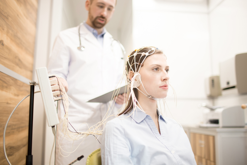 High-tech EEG cap on woman during neural research experiment at medical lab.