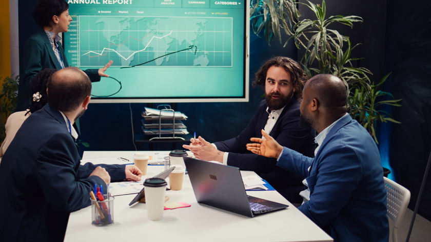 Analyzing market trends and data during a business presentation with diverse team members.