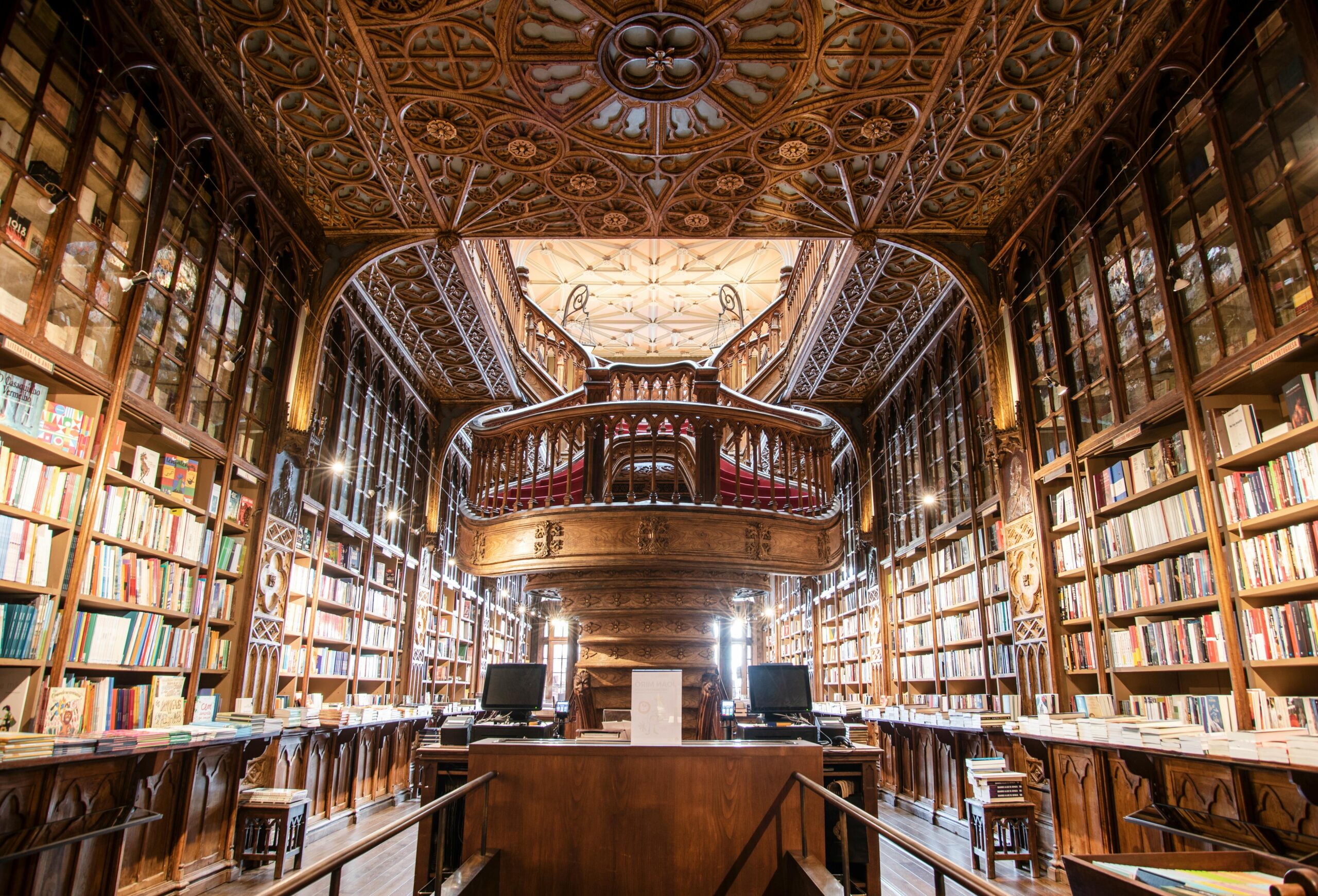 Stunning interior of a historic library filled with books, featuring ornate woodwork and high shelves for academic research.
