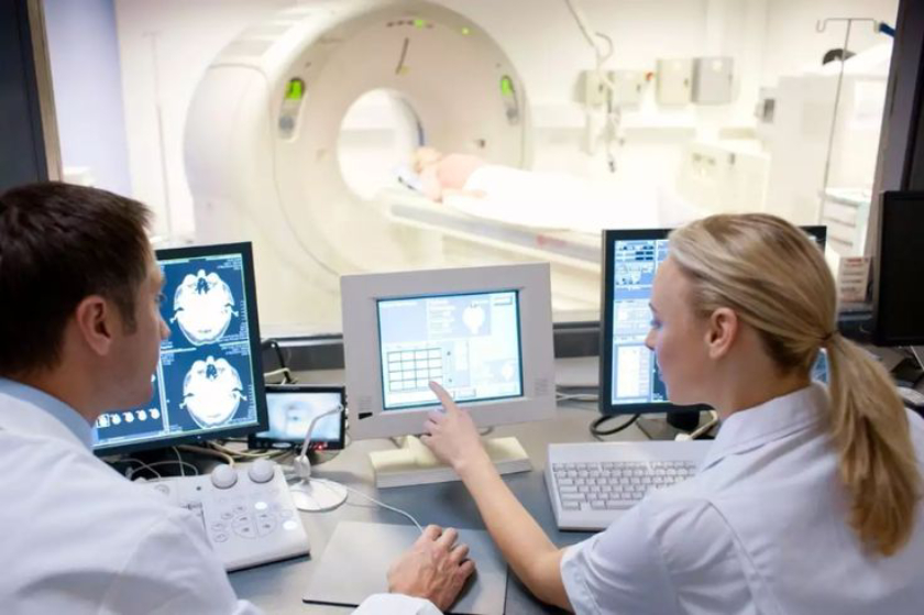 Doctors analyzing MRI scans at hospital.