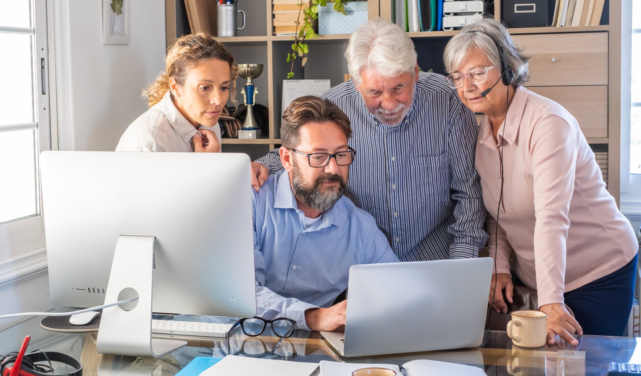 Close-up of diverse team examining data on a laptop for academic research.